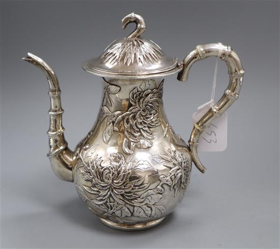 An early 20th century Chinese Export white metal coffee pot, embossed with chrysanthemums, maker HM?, gross 24.5 oz.